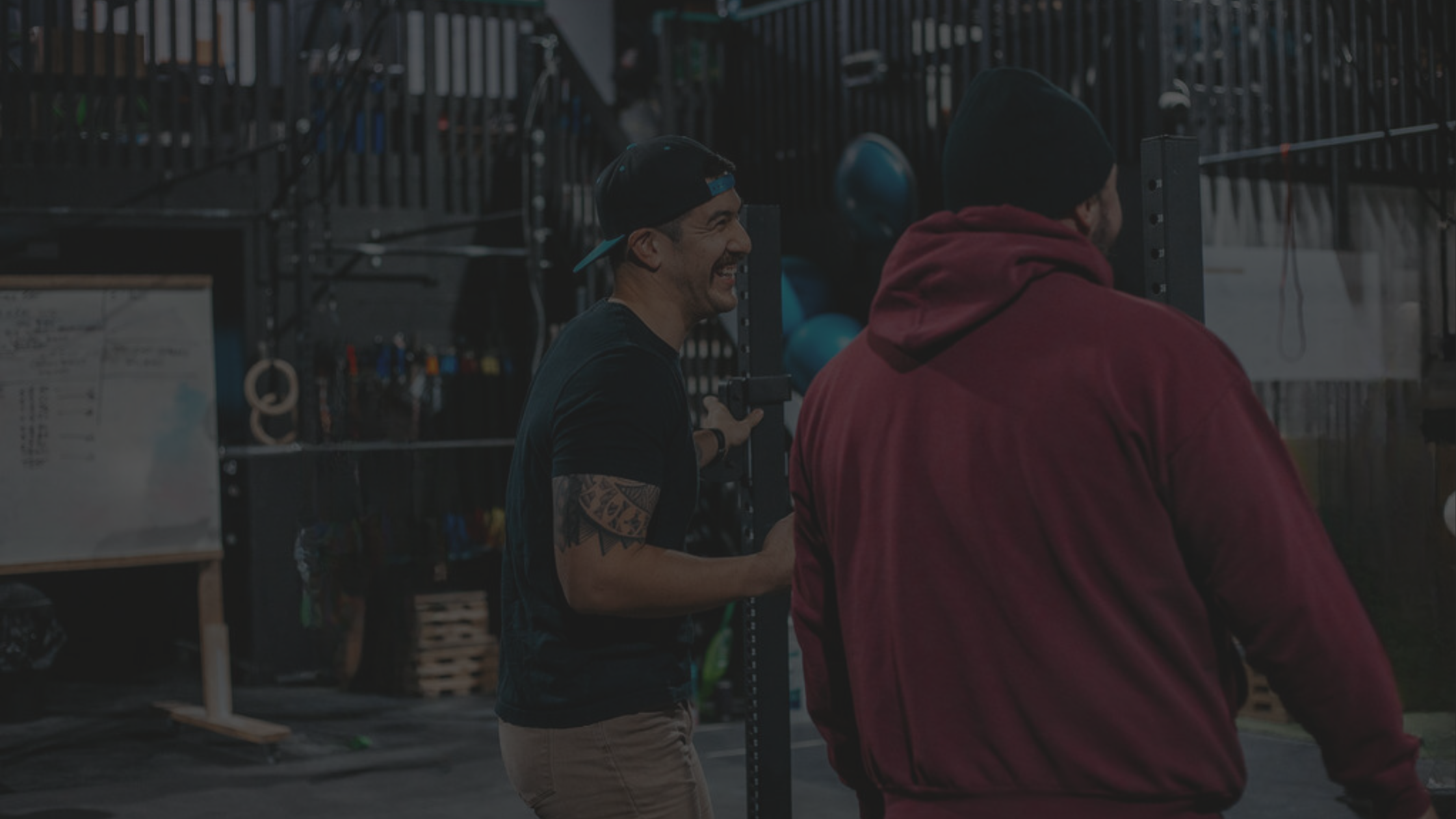 A coach and client laughing in the WholeFit gym in Lucan, Ontario during Semi-Private Training session.